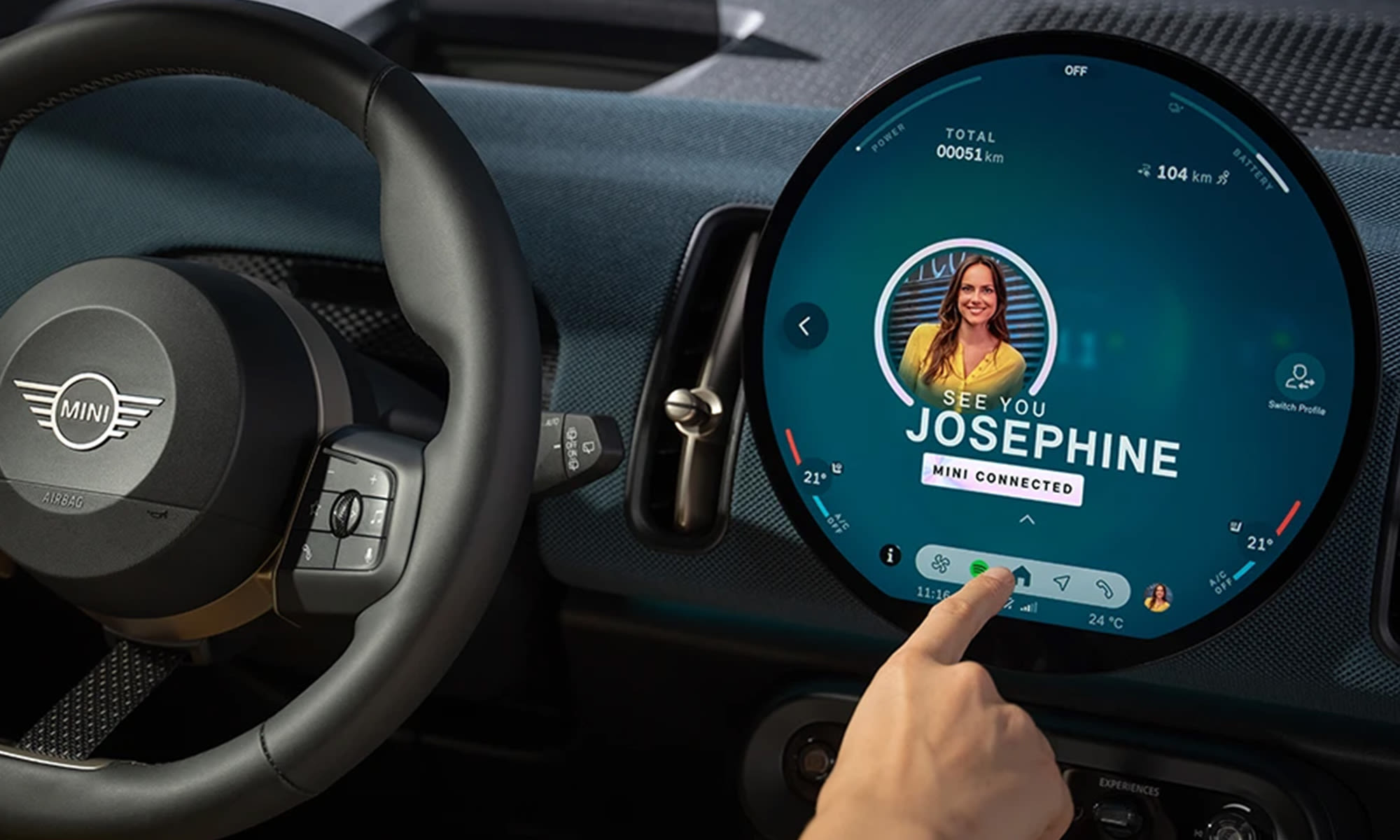 MINI interior showing the circular digital display with a MINI Connected user profile on screen.