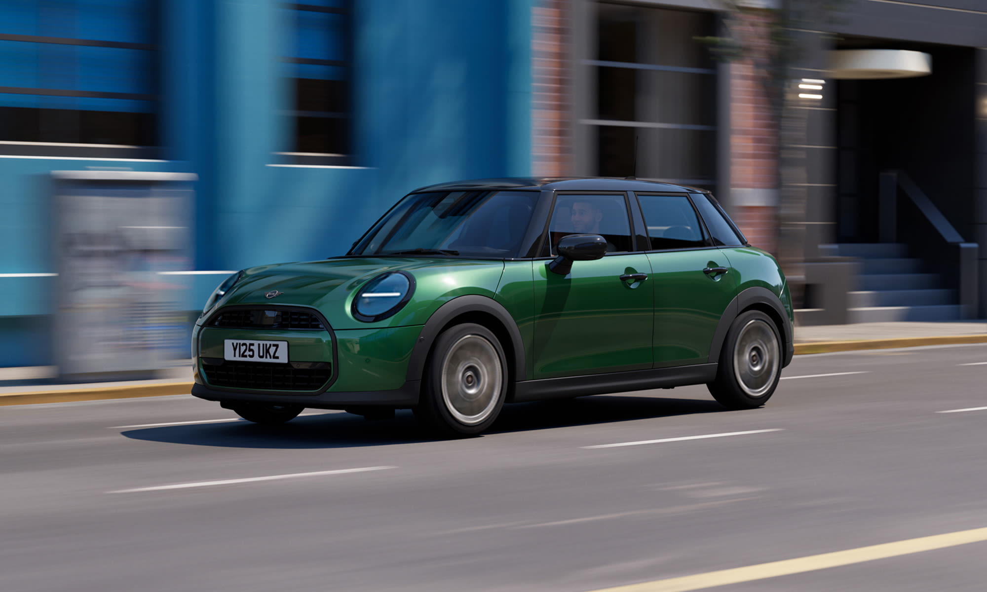 Green MINI Cooper 5-door driving along a city street.