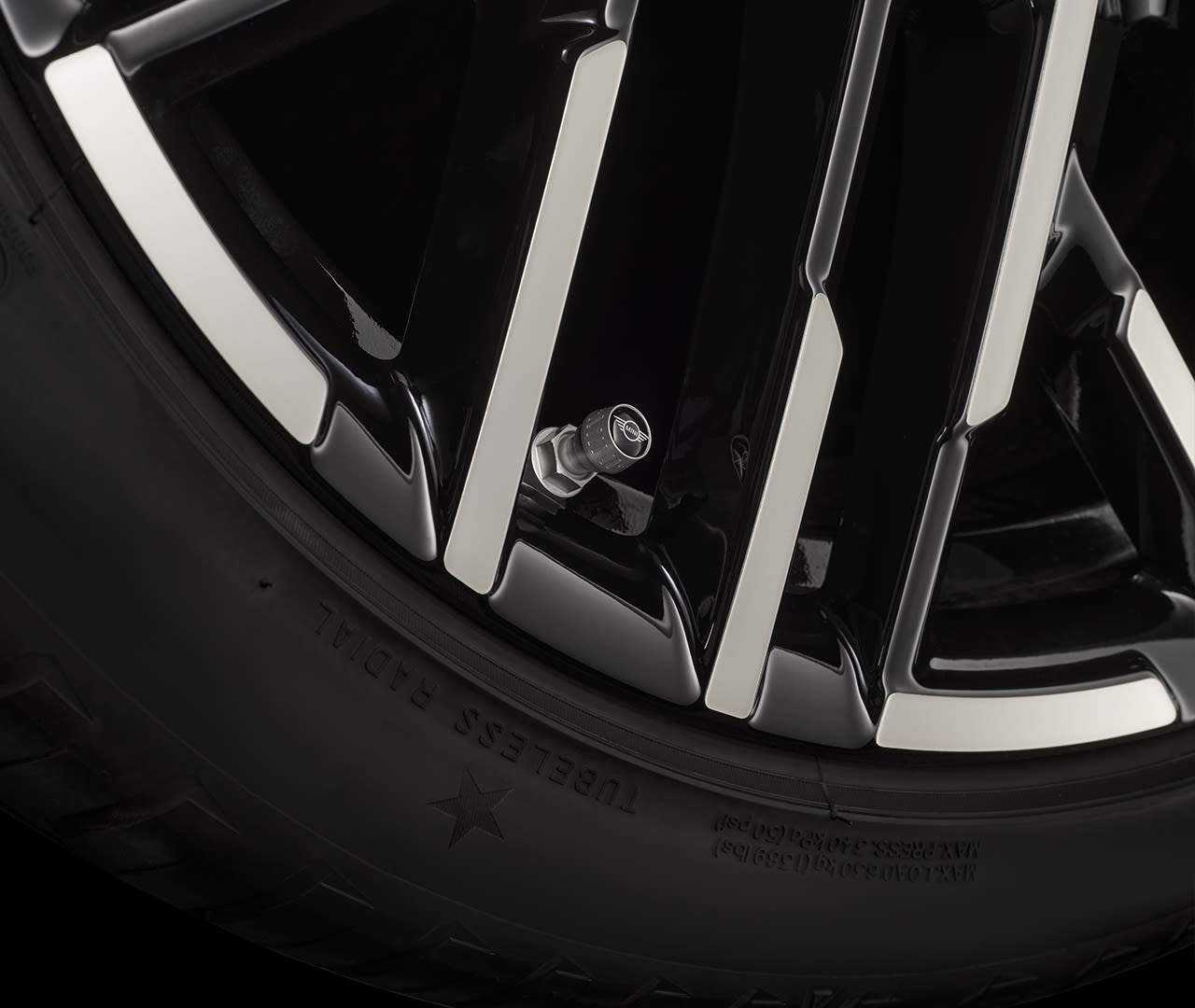 Close-up of a car tire and wheel rim with visible MINI valve cap.