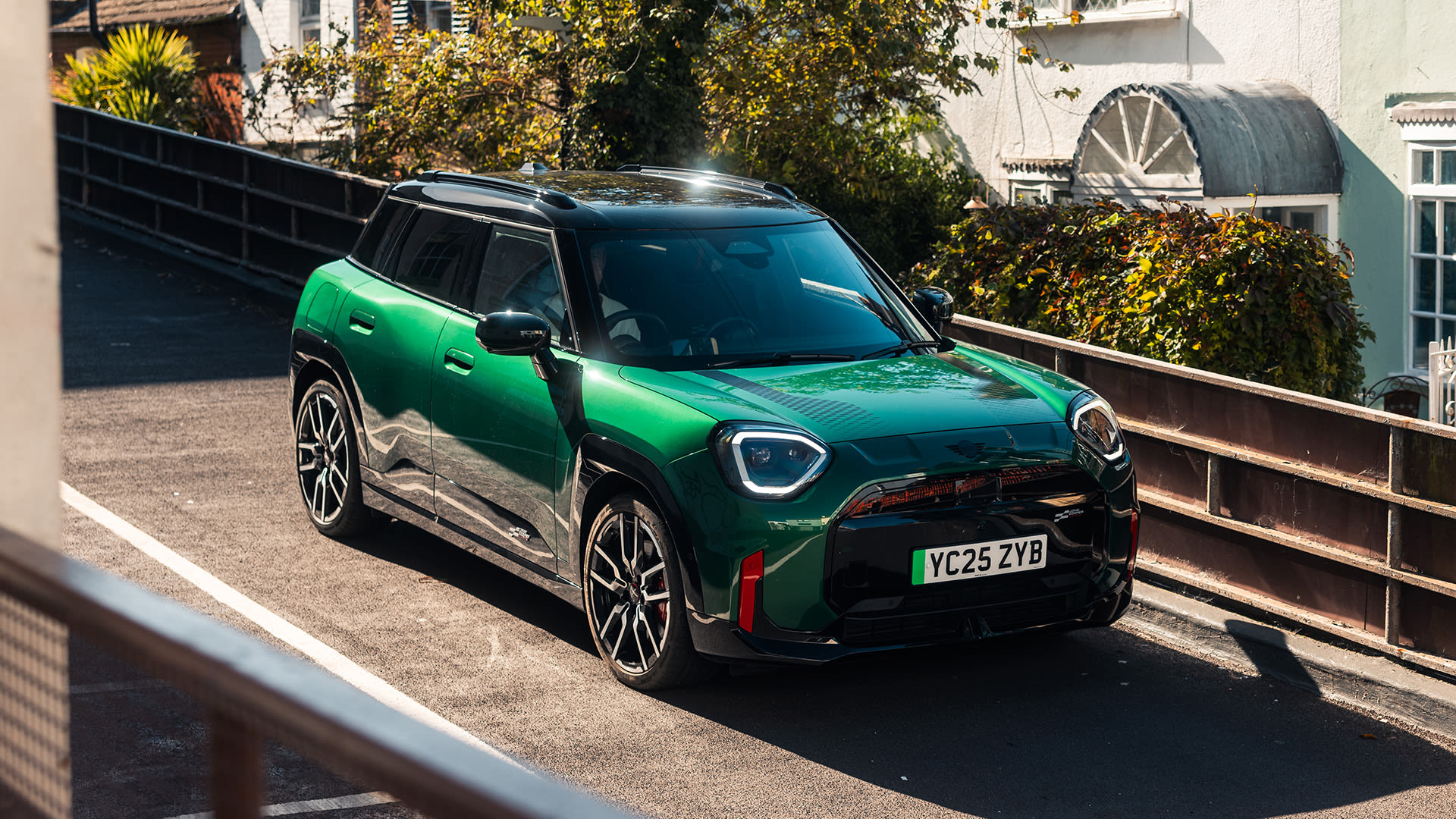 Green MINI Aceman on an elevated road.