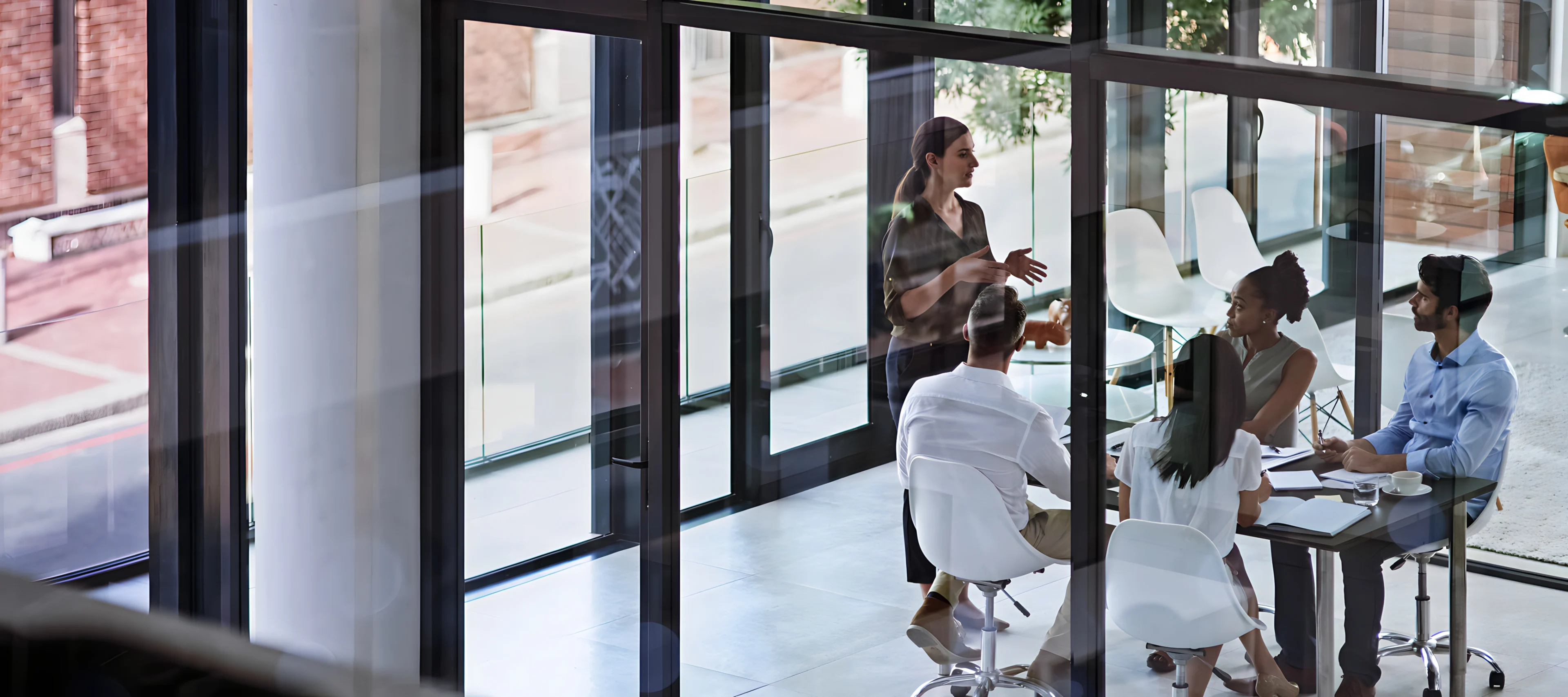 View through window of group of coworkers having a meeting