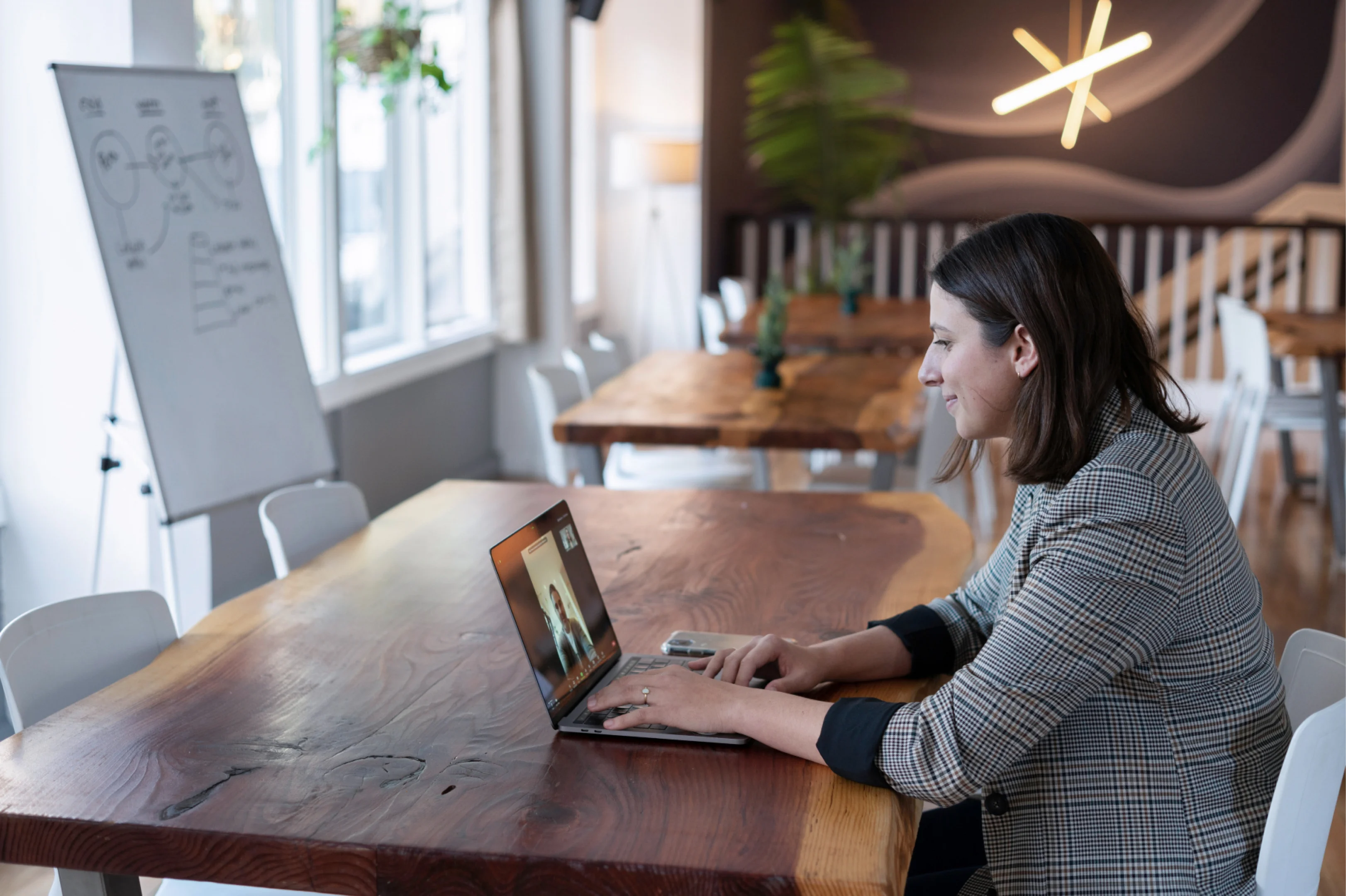 Woman on a video call on a laptop at a desk.