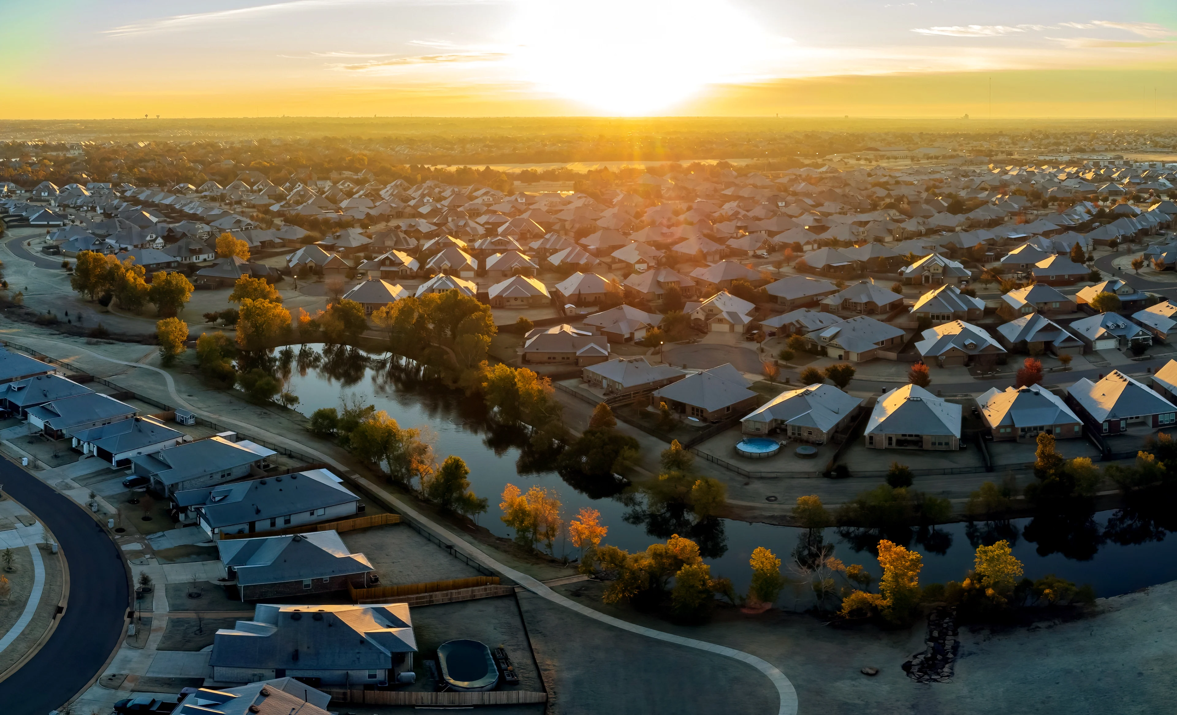 Sunrise over a neighborhood of homes