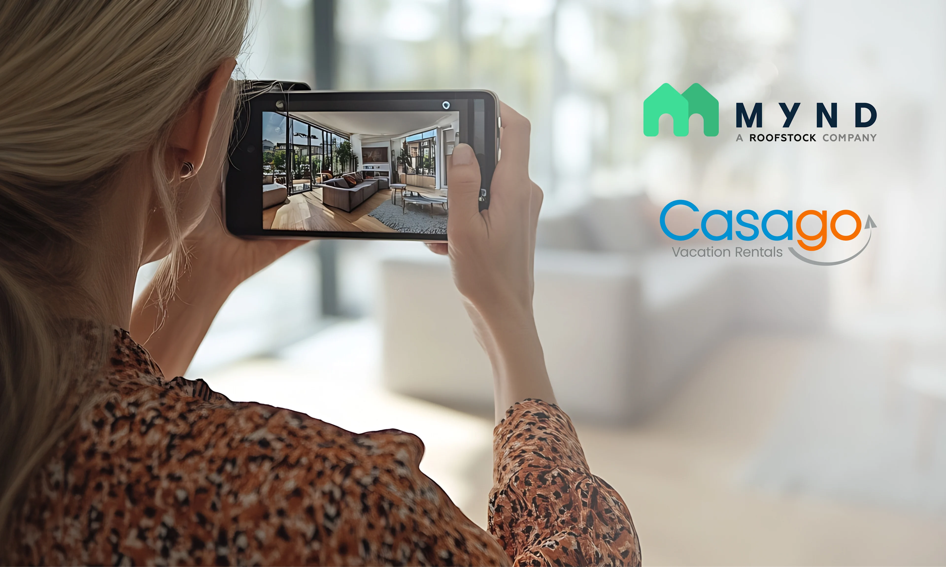 Mynd and Casago logos on photo of woman photographing a living room