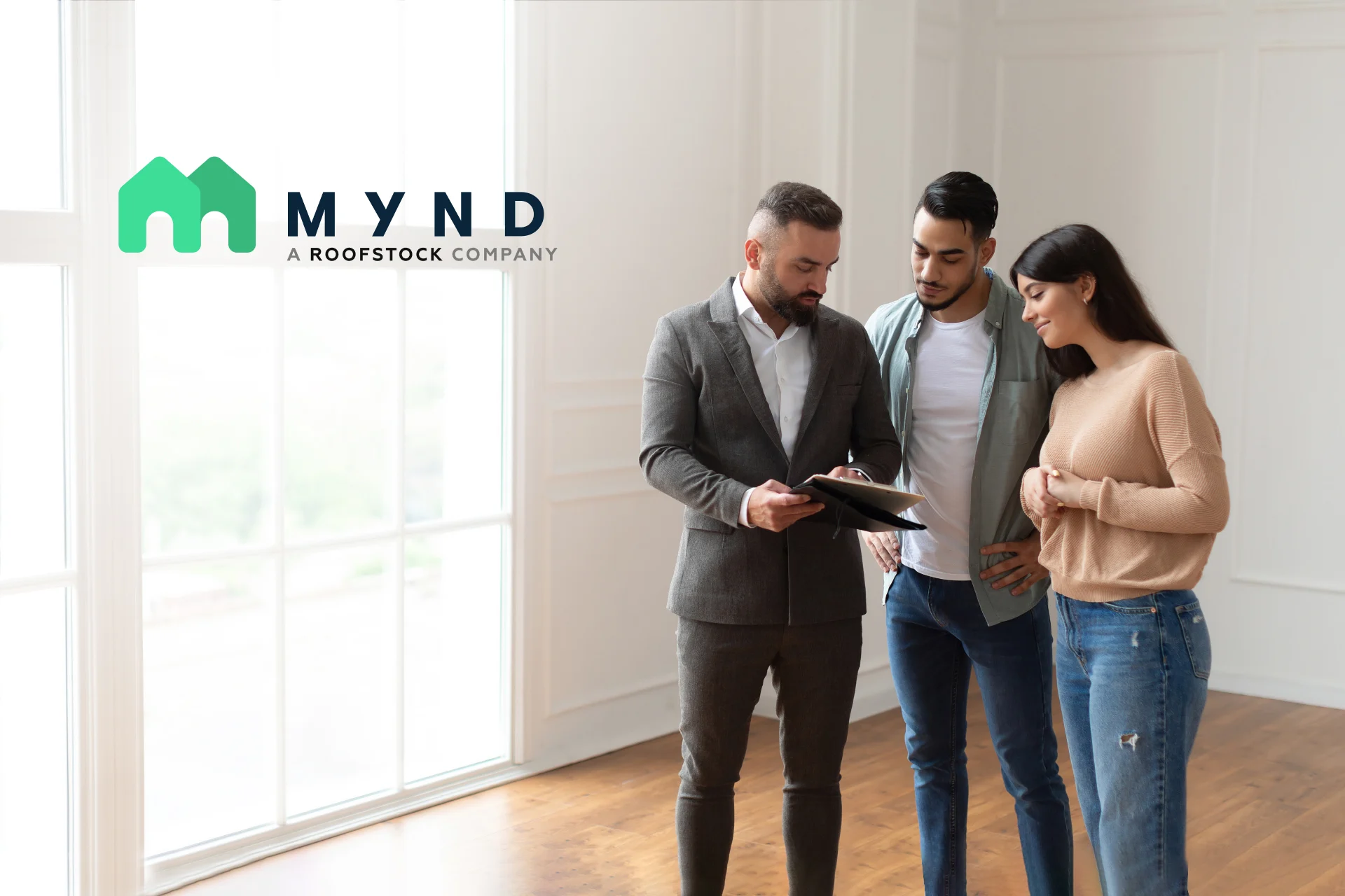 Mynd Agent showing paperwork to a couple