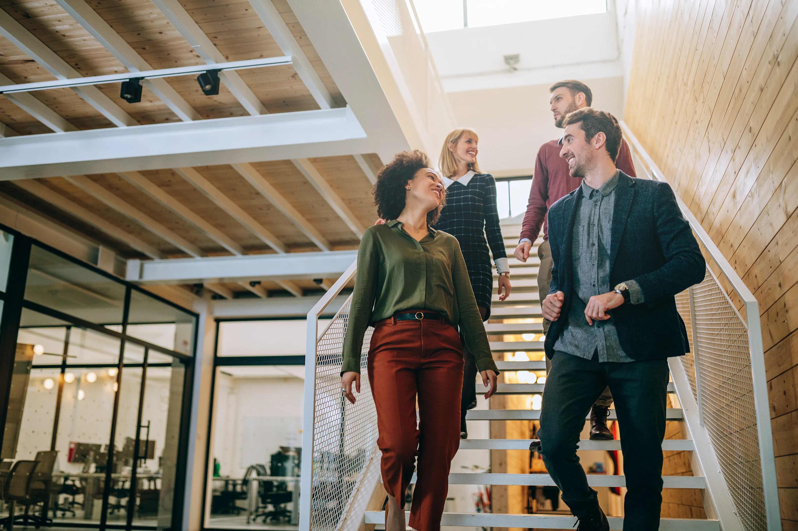 A group of people walking down stairs while talking