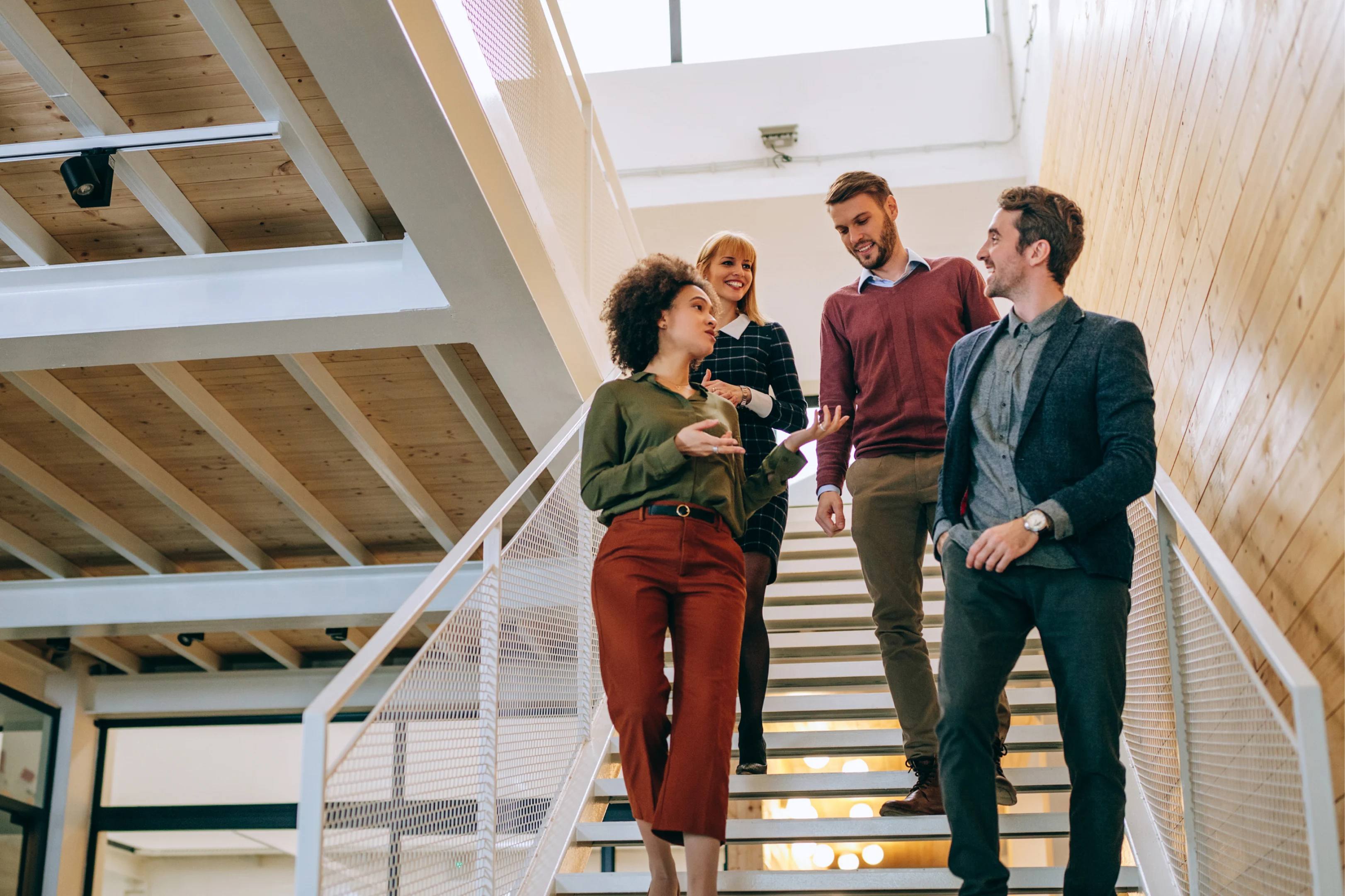 A group of people walking down stairs while talking