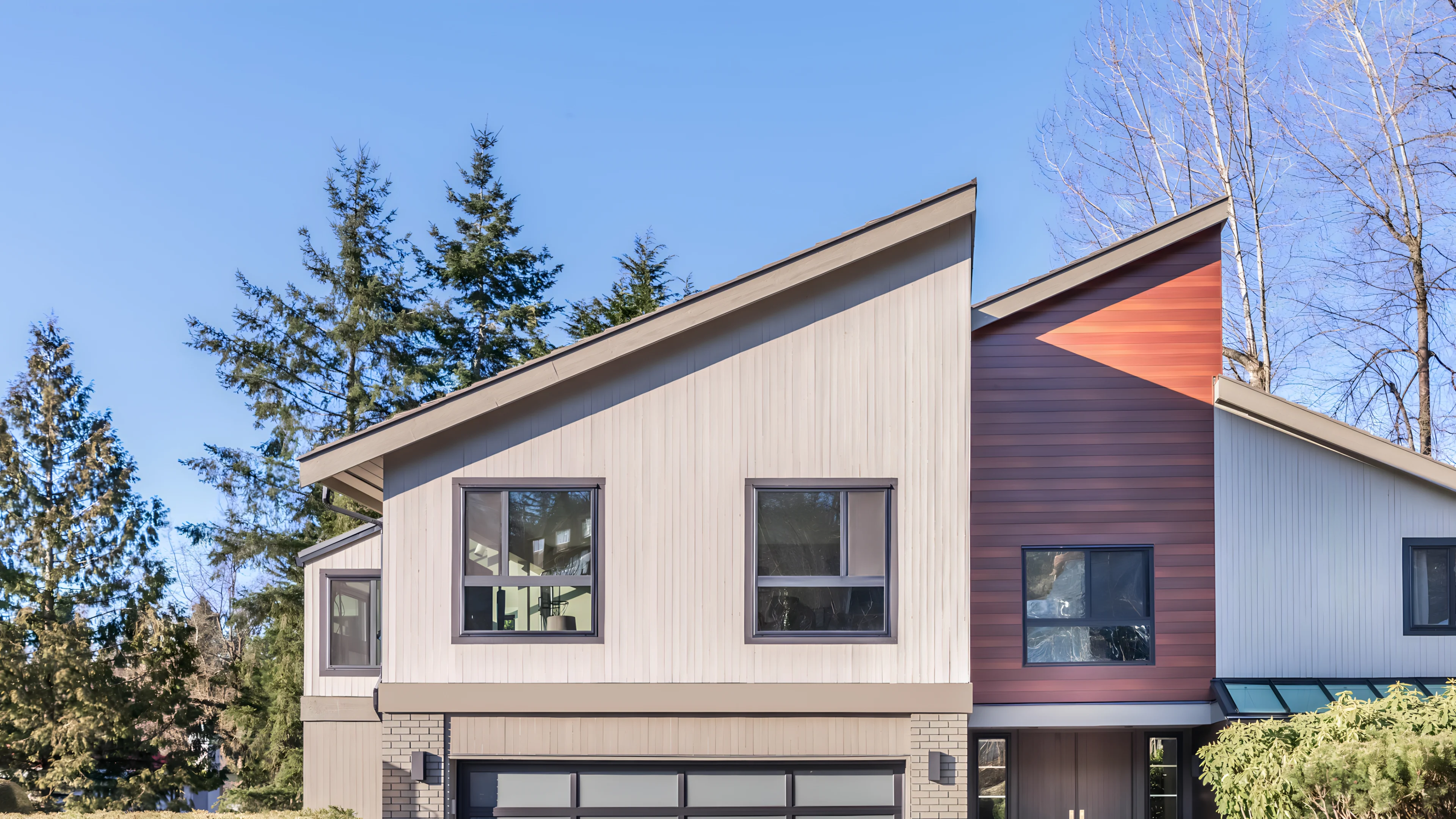 Modern home with angled roof and wooden paneling 