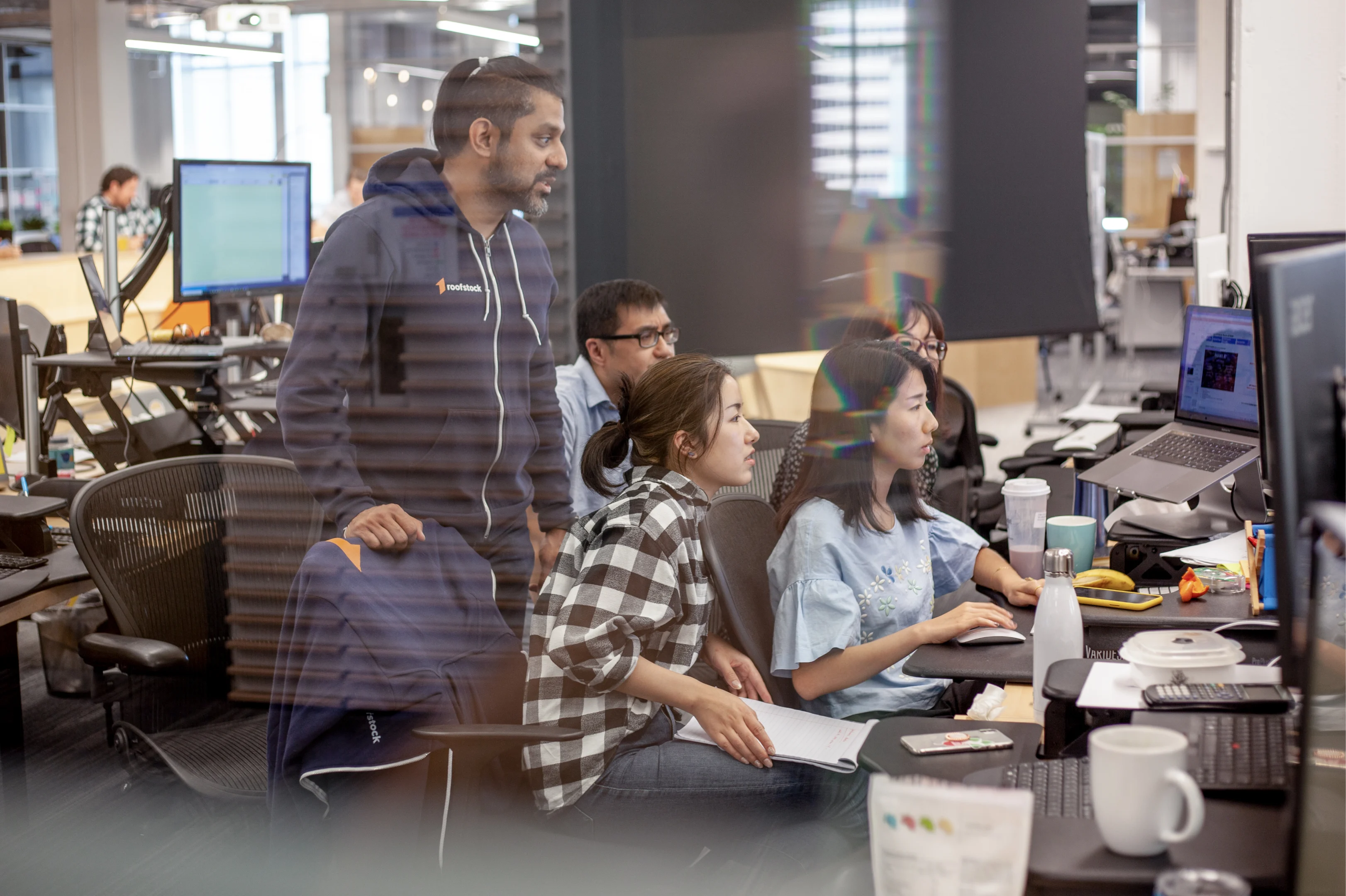 People huddled around a computer screen