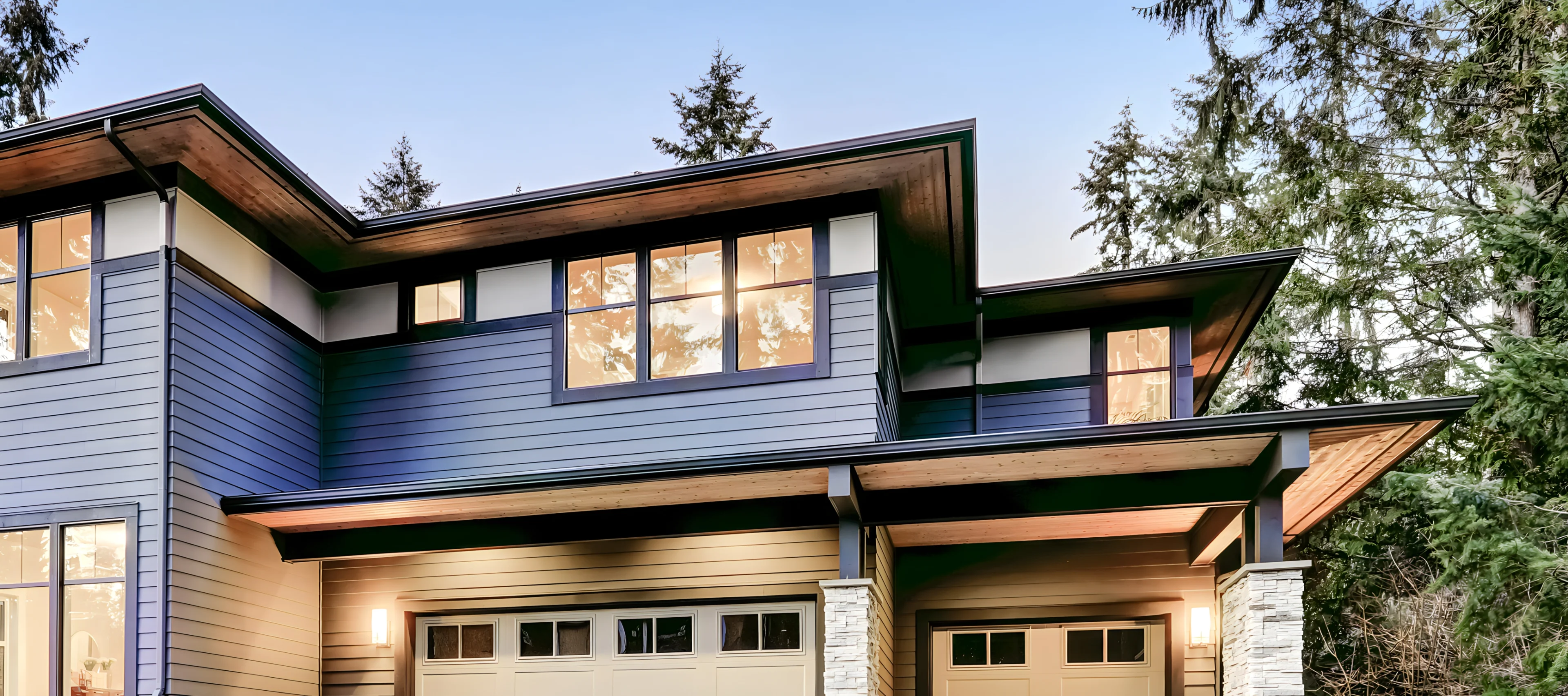 View of top level of a home with yellow reflections on windows