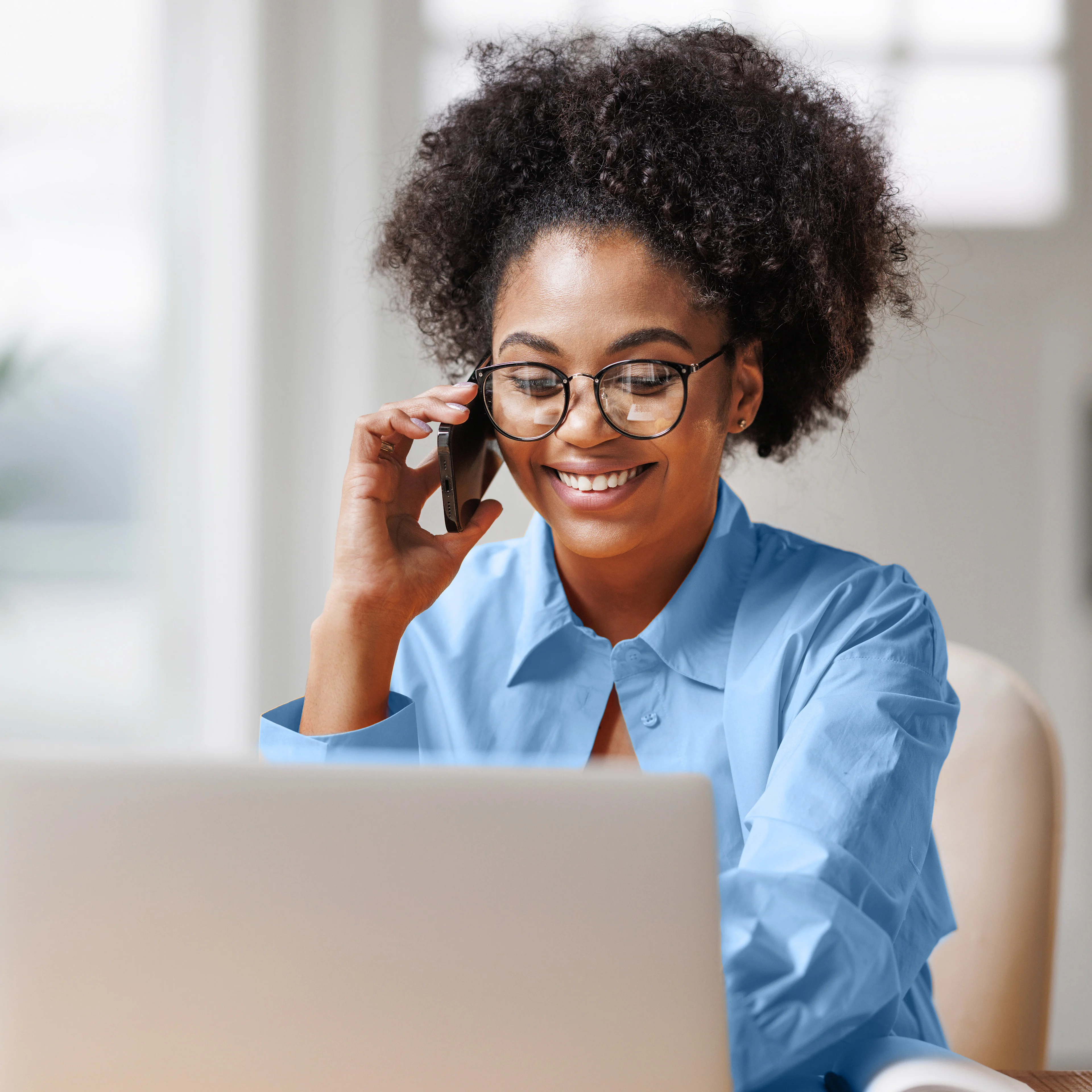 Woman on phone looking at computer