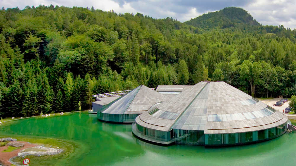 Redbull Fuschl Zentrale ausgestattet mit verschiedenen Produkten von BMI Österreich befindet sich auf einem grünen See umgeben von grünen Wäldern