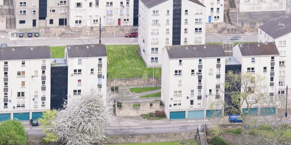 An aerial view of houses in a built-up area.