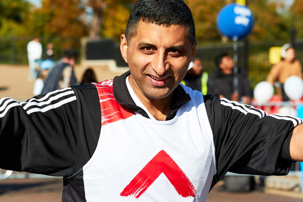 A Royal Parks Half marathon male runner smiles into camera centre justified 