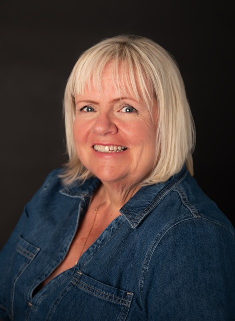 Photo of Annie Mauger-Thompson  of Shelter Scotland Committee, with blond hair and a blue denim too. She is smiling.
