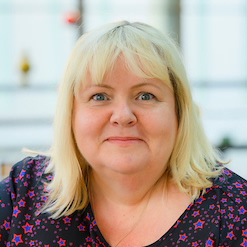 Photo of Annie Mauger-Thompson  of Shelter Scotland Committee, with blond hair and purple dress