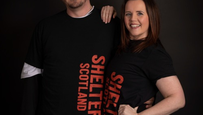 Two people wearing Shelter Scotland clothing