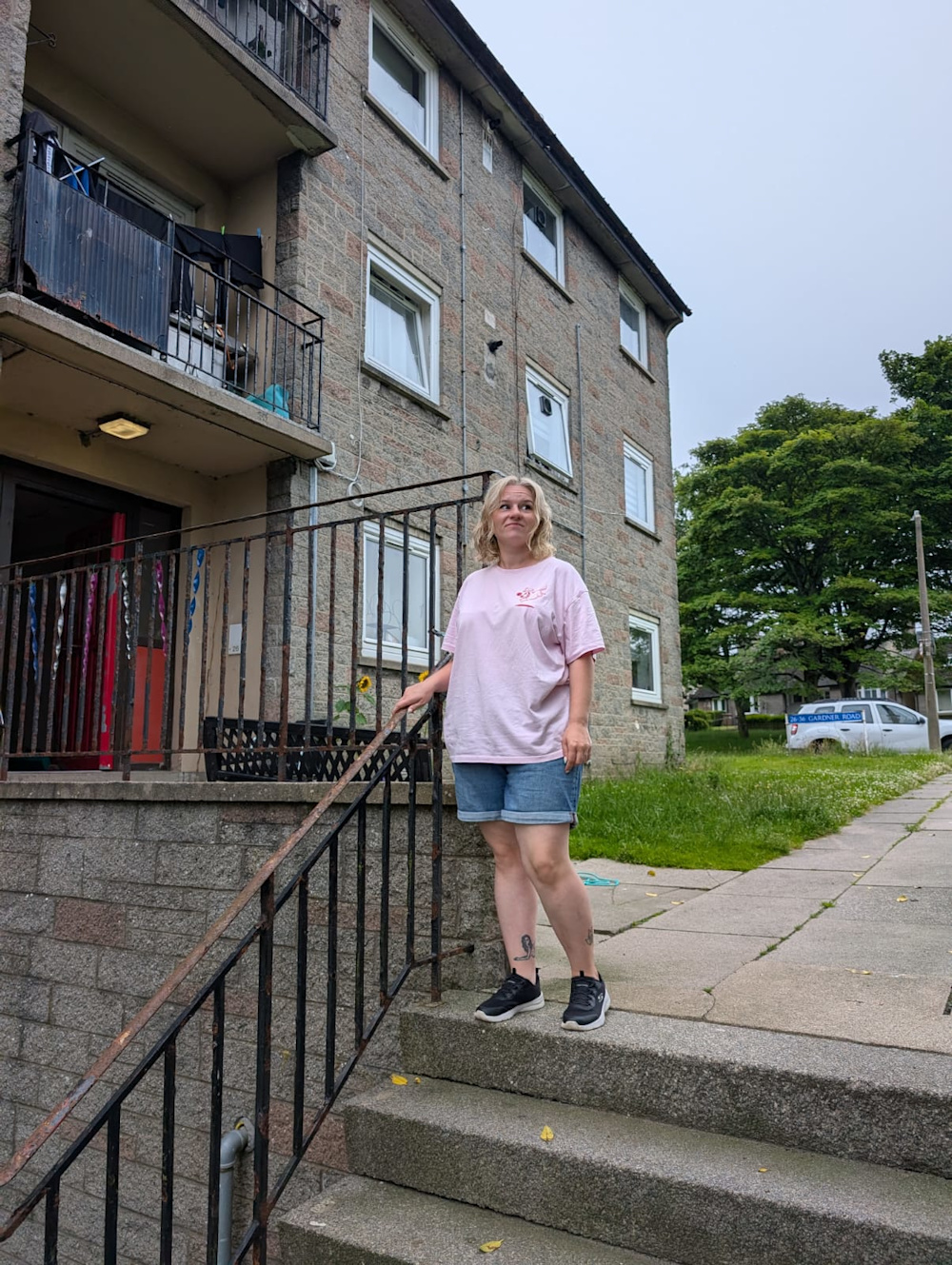 Kirstylee standing outside the block of flats