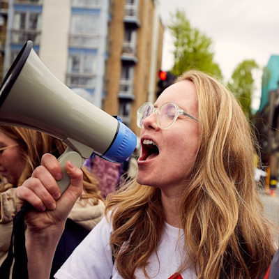 A woman shouts through a megaphone