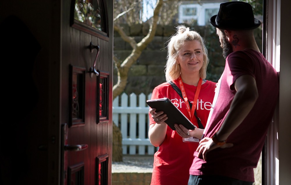 Shelter campaigner at front door with petition