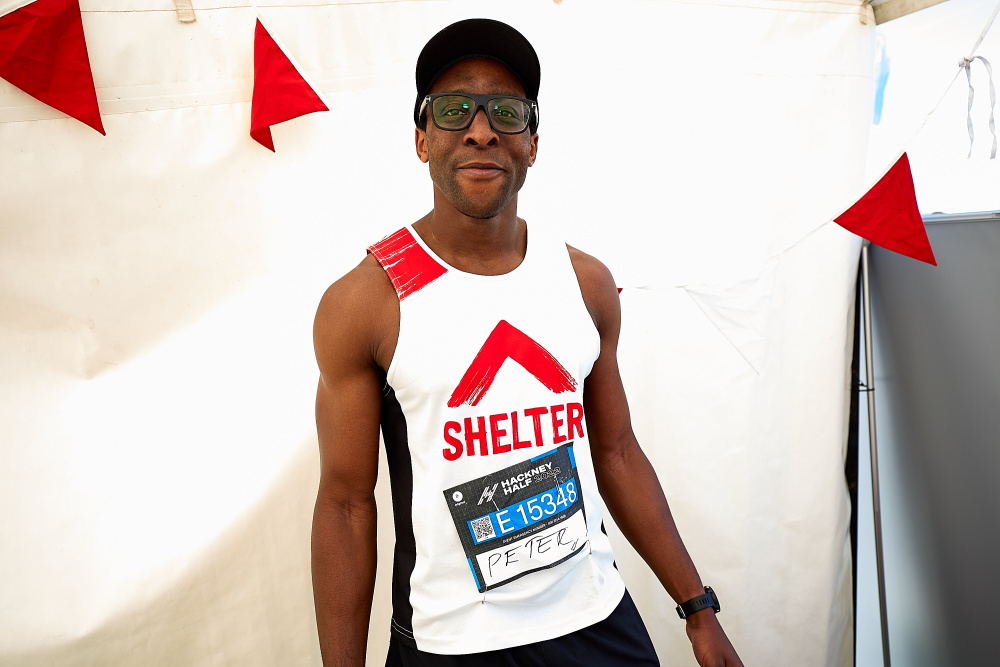A Hackney Half marathon runner wearing a Shelter vest wearing glasses looking straight at the camera in 2022