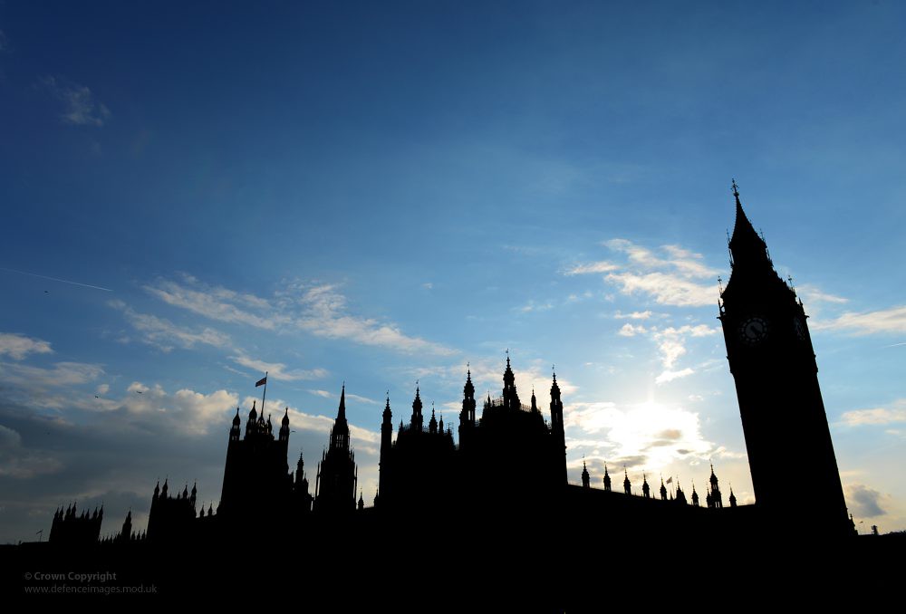 Silhouette of the Houses of Parliament against a clear sky.