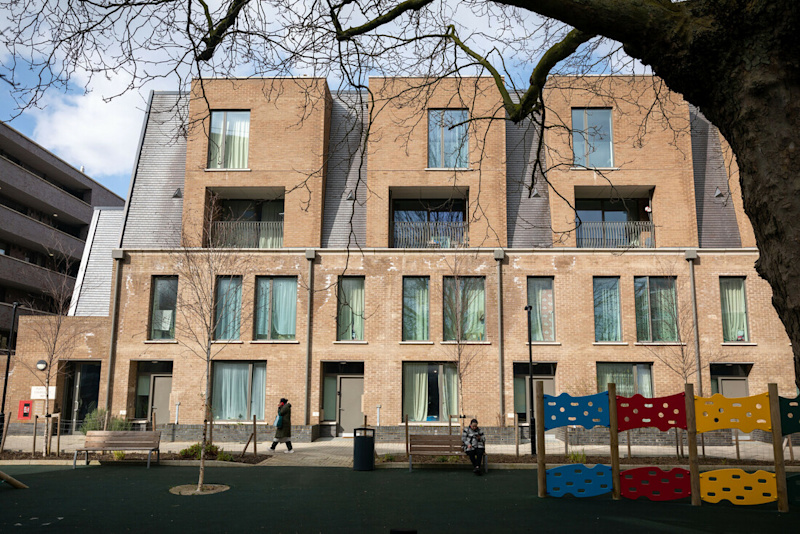 A brown social house with a communal playing ground in London