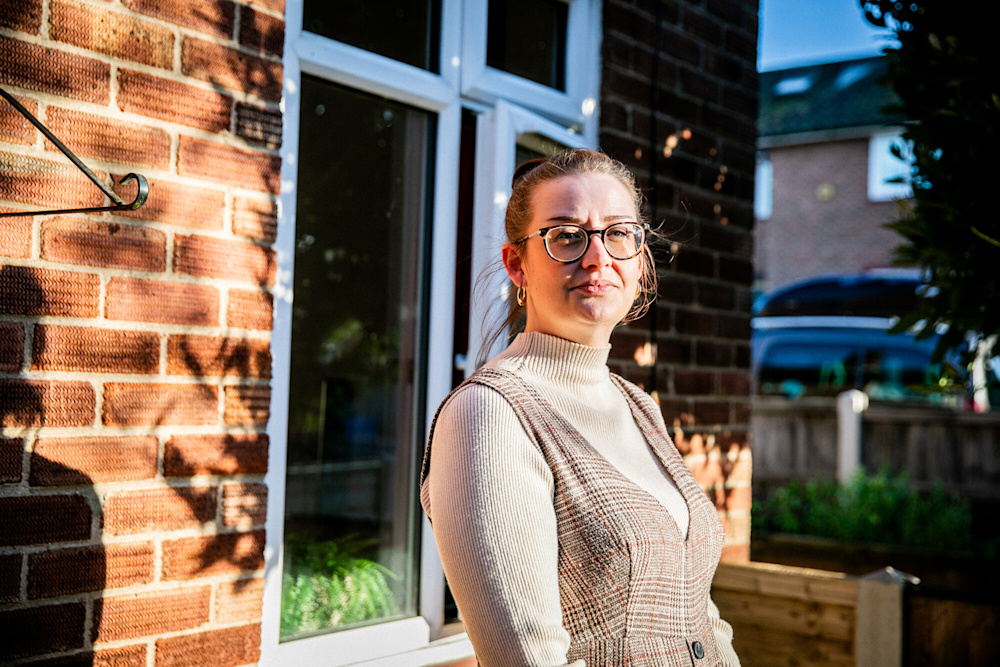 Picture of white woman standing outside social home