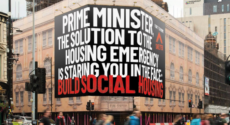 A Shelter banner suspended across a building near Westminster that reads: 'Prime Minister, the solution to the housing emergency is staring you in the face: Build social housing'