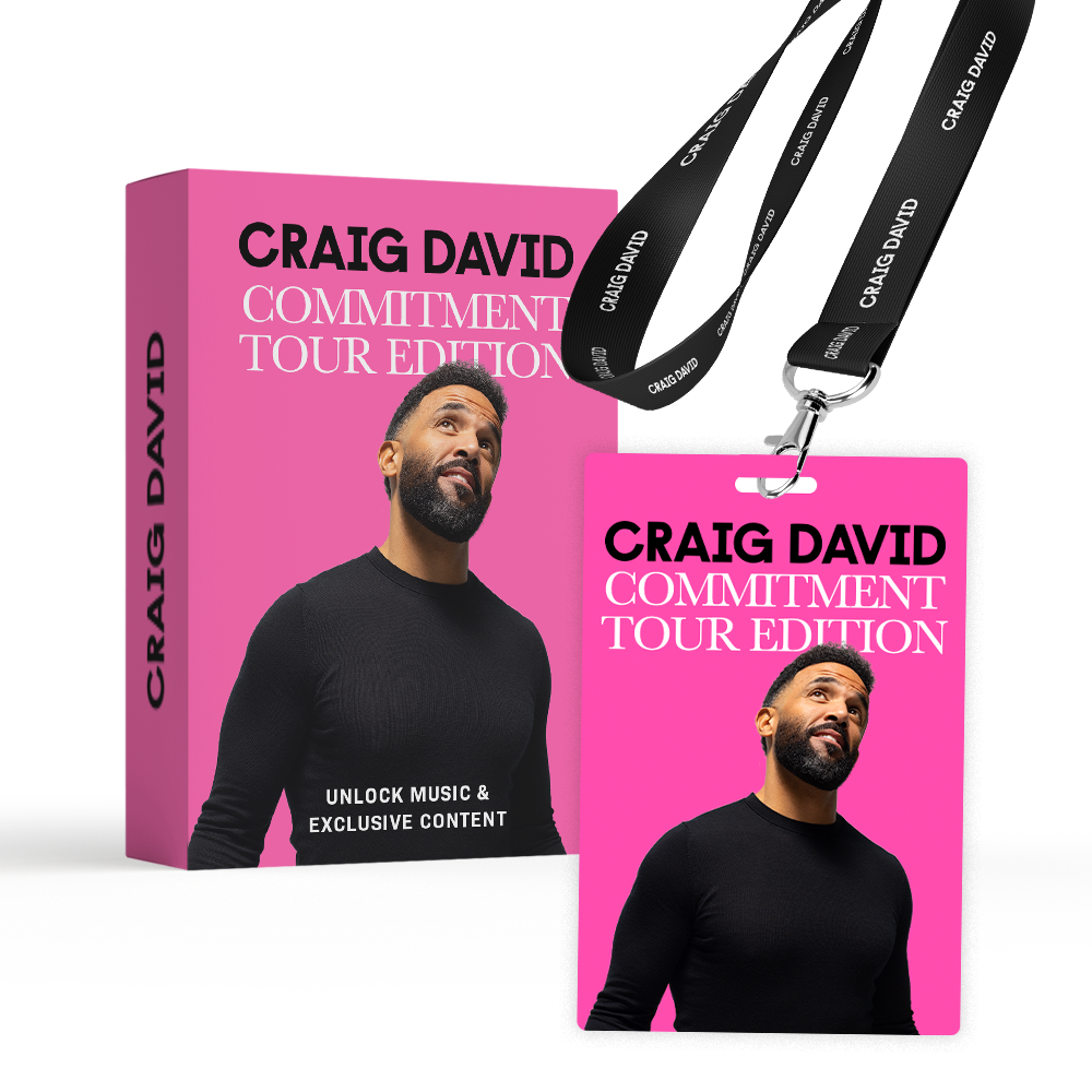 Photo of the limited edition 'Commitment' tour lanyards available at selected Shelter shops. There is the box and the lanyard (the lanyard has a photo of Craig David wearing black jumper against a bright pink background and the text reads - Craig David Commitment Tour Edition)