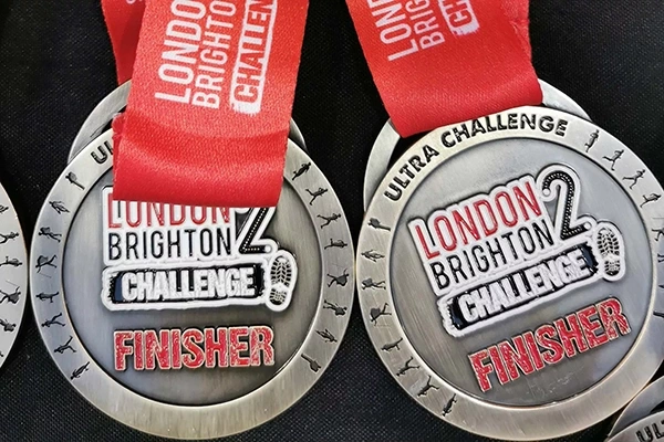 Two silver medals with text reading 'London 2 Brighton Challenge Finisher'