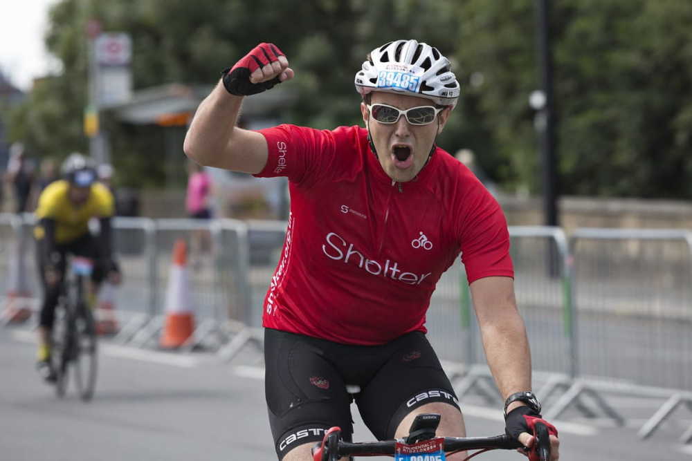 A cyclist pumps his fist in triumph 