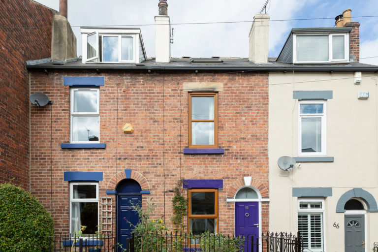 A row of terraced houses, with blue doors.