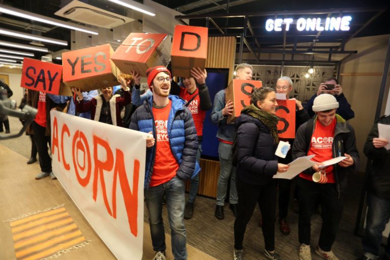 A group of ACORN campaigners holding signs that spell out 'Say Yes to DSS'