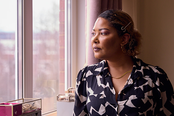 Sireena looks out of the window of her flat