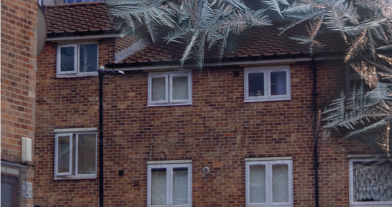 Photo of a two-storey house surrounded by icicle graphics