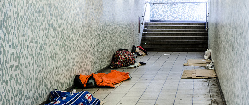 A public passageway with sleeping bags and cardboard from rough sleepers.