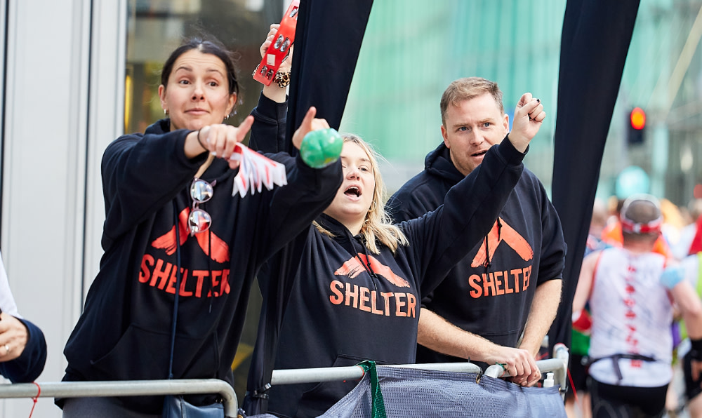 Shelter supporters cheering at the marathon with Shelter hoodies