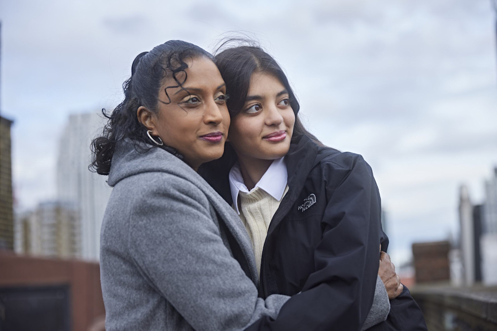 Natalie and her daughter Tia hug each other.