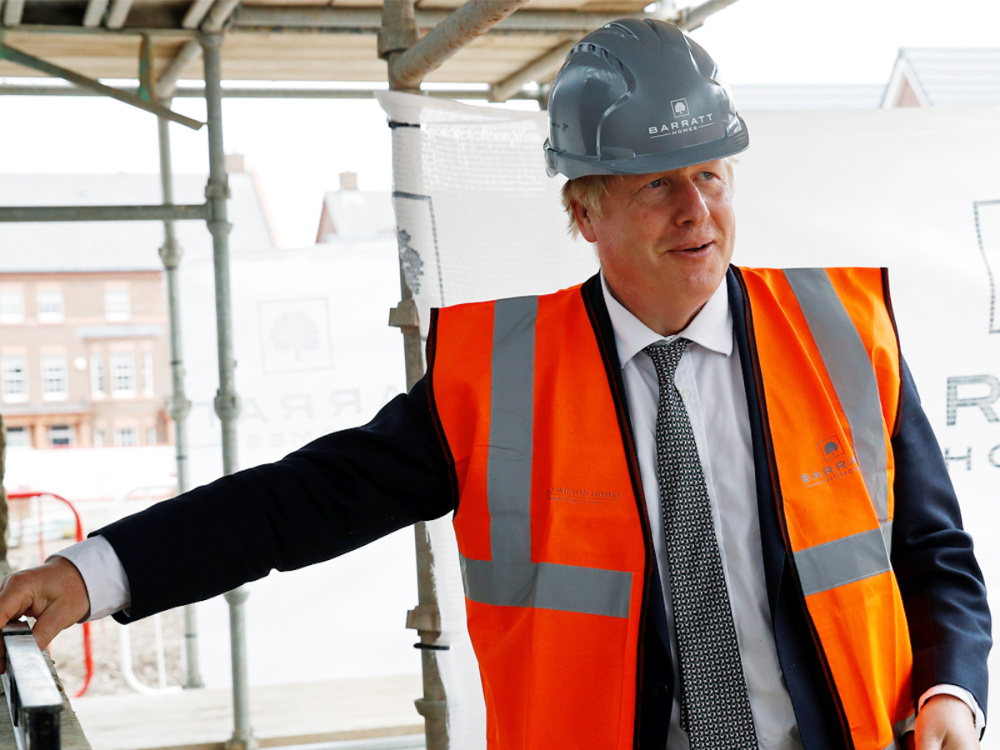 PM Boris Johnson wearing construction gear on a building site.