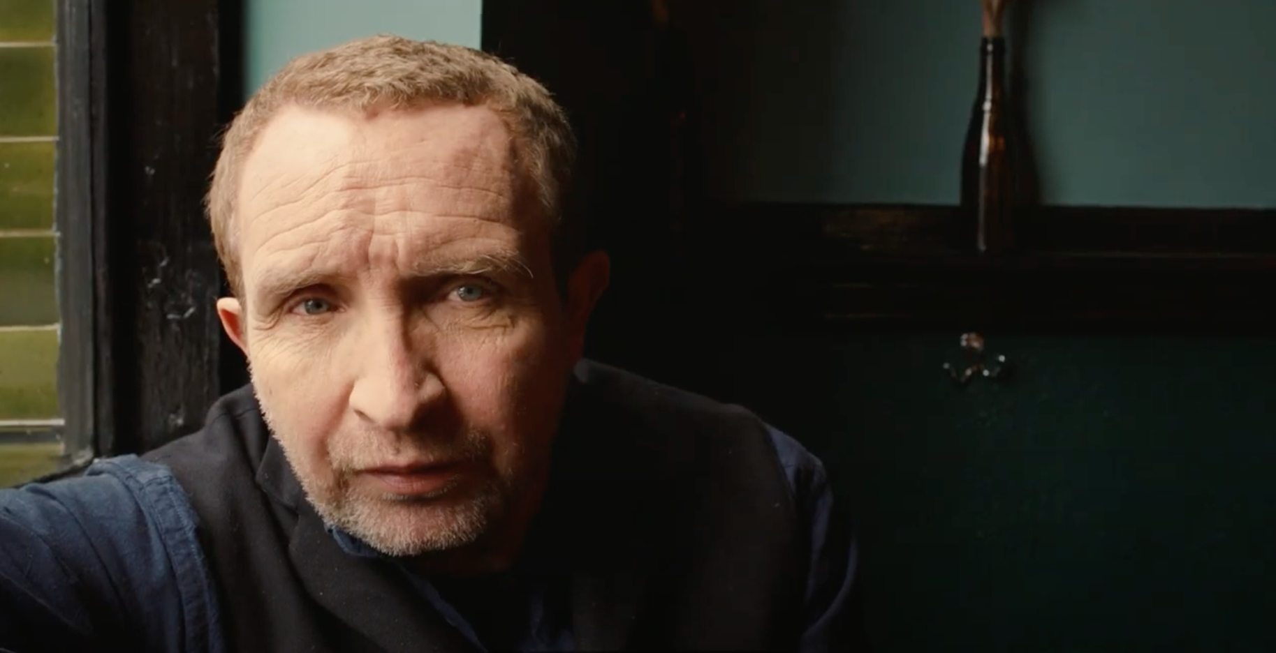 Actor Eddie Marsan, wearing a navy blue shirt and jacket.