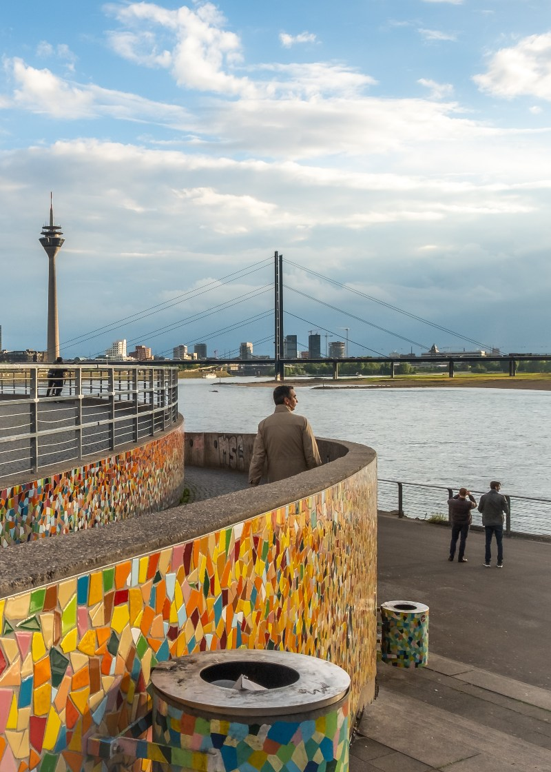 Image of person standing by a river bank in Dusseldorf Germany