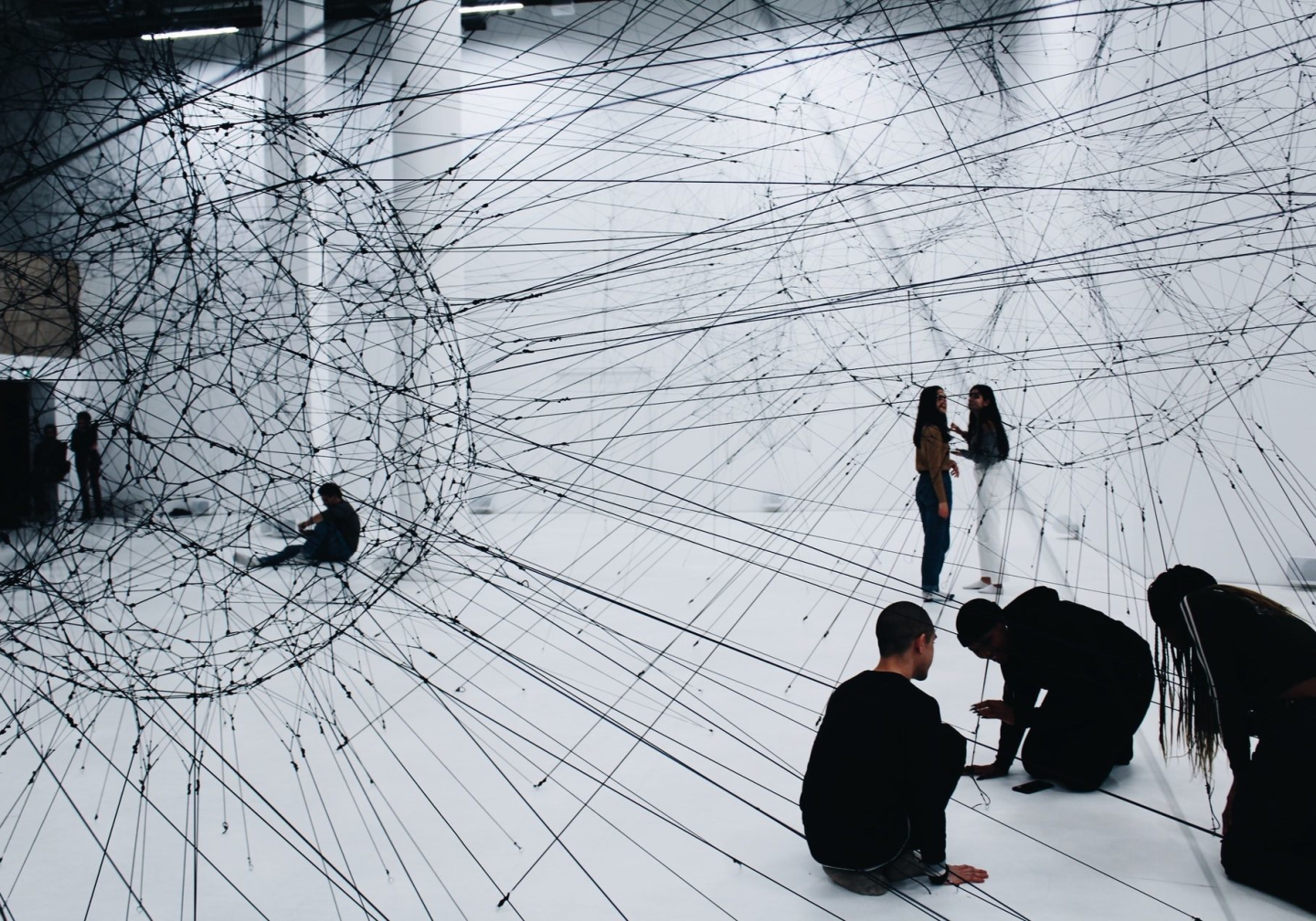 People sitting and standing with inter connecting lines