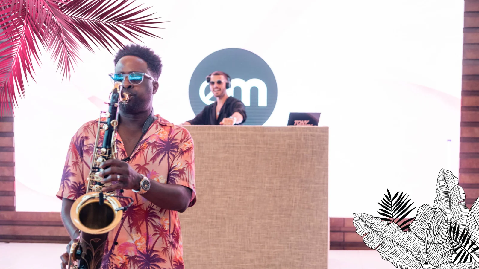 Person playing saxophone with a DJ in the background at an EssenceMediacom event in Cannes 2023