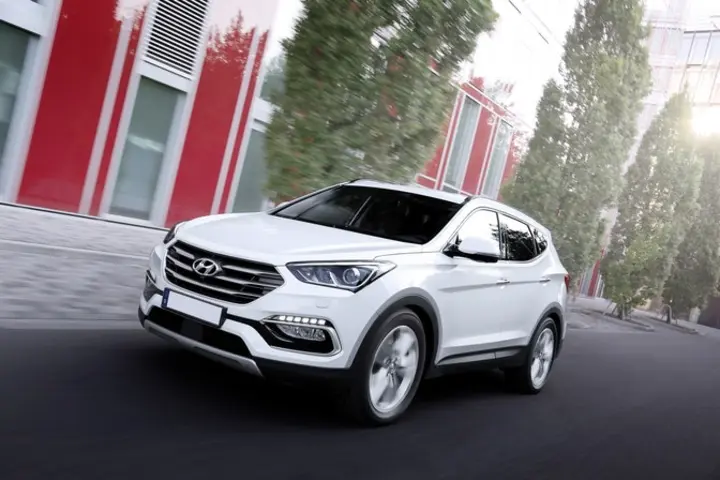 The front exterior of a white Hyundai Santa Fe