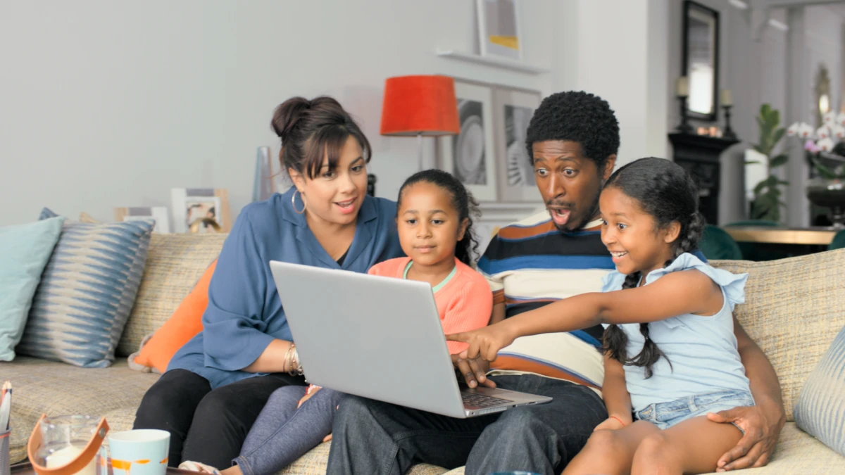 Familie am Laptop: Eltern mit zwei Kinder - Cazoo