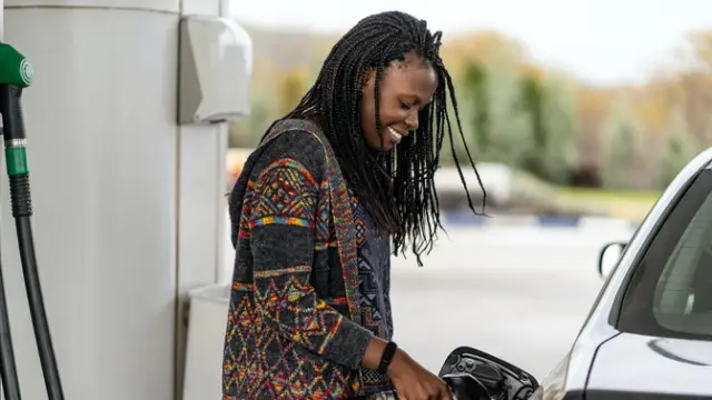 Lady at fuel pump filling up her car