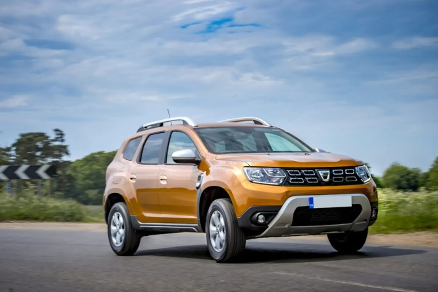The front exterior of a gold Dacia Duster