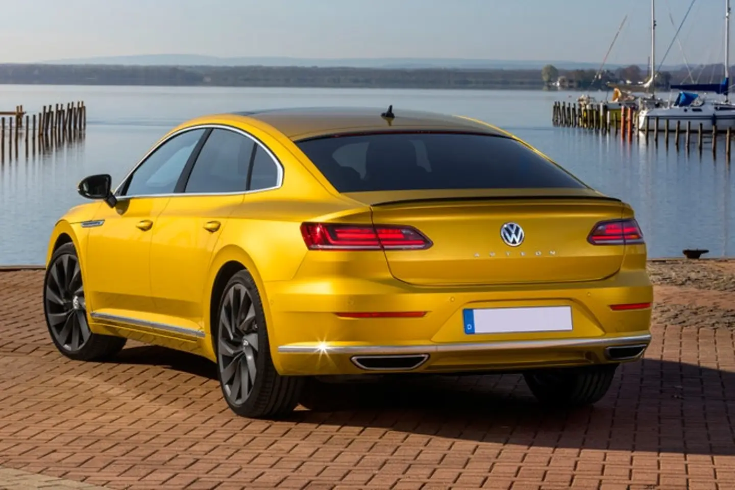 The rear exterior of a yellow Volkswagen Arteon