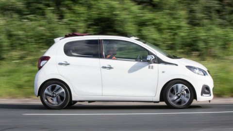 The side exterior of a white Peugeot 108